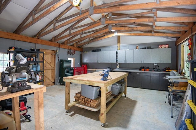 2878 Fly Rd, Santa Fe, TN 38482 - misc room featuring a workshop area, vaulted ceiling, unfinished concrete flooring, and a garage
