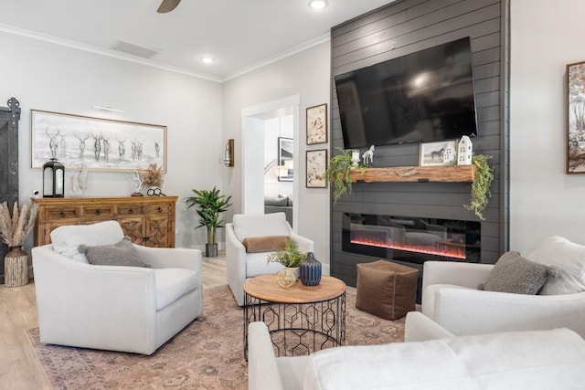 2878 Fly Rd, Santa Fe, TN 38482 - living area with wood finished floors, a glass covered fireplace, ornamental molding, and recessed lighting