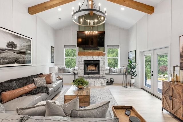 2878 Fly Rd, Santa Fe, TN 38482 - living room with wood finished floors, beamed ceiling, a chandelier, a stone fireplace, and a decorative wall