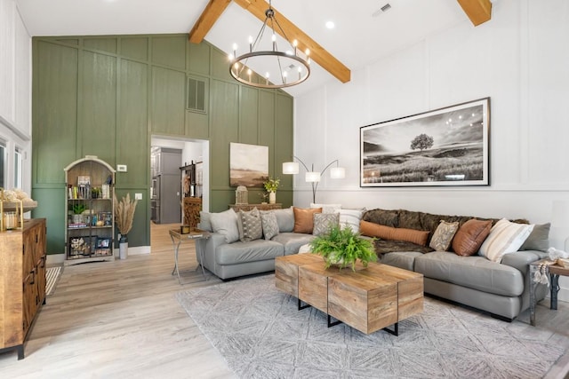 2878 Fly Rd, Santa Fe, TN 38482 - living room featuring a decorative wall, beamed ceiling, light wood-type flooring, a chandelier, and high vaulted ceiling