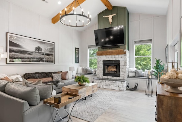 2878 Fly Rd, Santa Fe, TN 38482 - living room featuring a stone fireplace, wood finished floors, and a chandelier