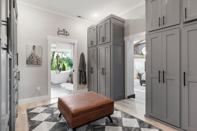 2878 Fly Rd, Santa Fe, TN 38482 - bathroom with a freestanding bath, ornamental molding, a closet, baseboards, and wood finished floors