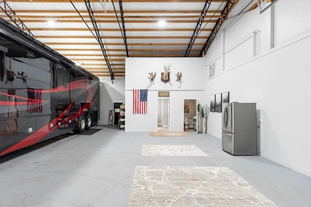 2878 Fly Rd, Santa Fe, TN 38482 - garage with freestanding refrigerator and baseboards