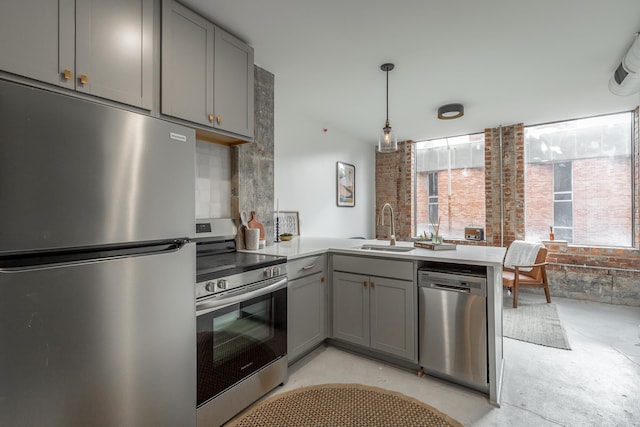 117 E 7th St Unit 302, Chattanooga, TN 37402 - kitchen featuring appliances with stainless steel finishes, gray cabinetry, a sink, a peninsula, and concrete floors