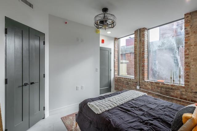 117 E 7th St Unit 302, Chattanooga, TN 37402 - bedroom featuring brick wall, baseboards, a chandelier, and recessed lighting