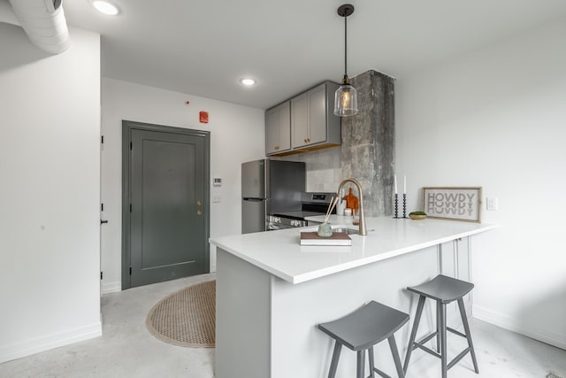 117 E 7th St Unit 302, Chattanooga, TN 37402 - kitchen with a sink, stainless steel appliances, gray cabinetry, a kitchen bar, and baseboards