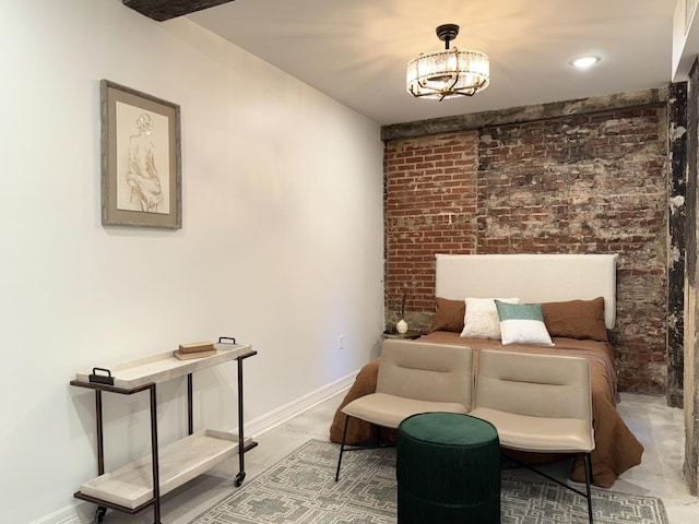 117 E 7th St Unit 503, Chattanooga, TN 37402 - bedroom with brick wall, baseboards, and a chandelier