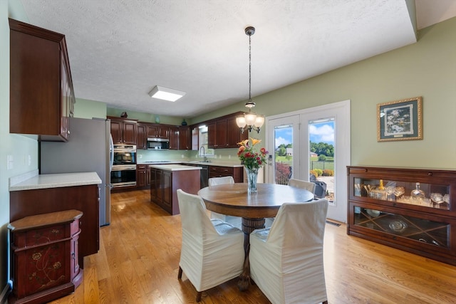 502 Tarver Ct, Smyrna, TN 37167 - dining room with light wood-type flooring and a textured ceiling