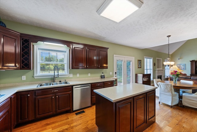 502 Tarver Ct, Smyrna, TN 37167 - kitchen with stainless steel dishwasher, a sink, a textured ceiling, light wood-type flooring, and light countertops