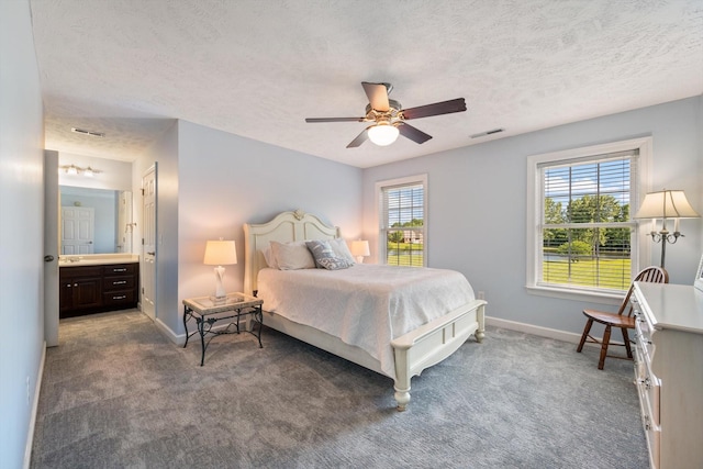 502 Tarver Ct, Smyrna, TN 37167 - carpeted bedroom featuring baseboards, a textured ceiling, a ceiling fan, and ensuite bath