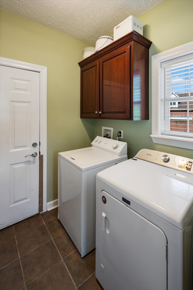 502 Tarver Ct, Smyrna, TN 37167 - laundry room with cabinet space, separate washer and dryer, dark tile patterned floors, a textured ceiling, and baseboards