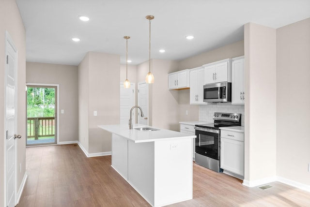 102 Colson Rd, Dover, TN 37058 - kitchen with appliances with stainless steel finishes, a sink, baseboards, light wood finished floors, and recessed lighting
