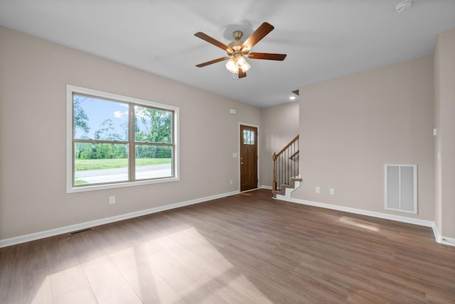 102 Colson Rd, Dover, TN 37058 - unfurnished living room with stairs, a ceiling fan, baseboards, and wood finished floors