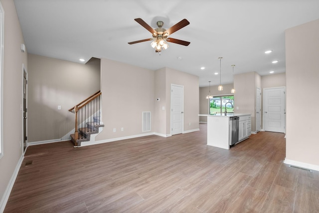 102 Colson Rd, Dover, TN 37058 - unfurnished living room featuring a ceiling fan, stairway, recessed lighting, light wood-type flooring, and baseboards