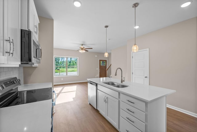 102 Colson Rd, Dover, TN 37058 - kitchen featuring stainless steel appliances, a sink, wood finished floors, baseboards, and white cabinetry
