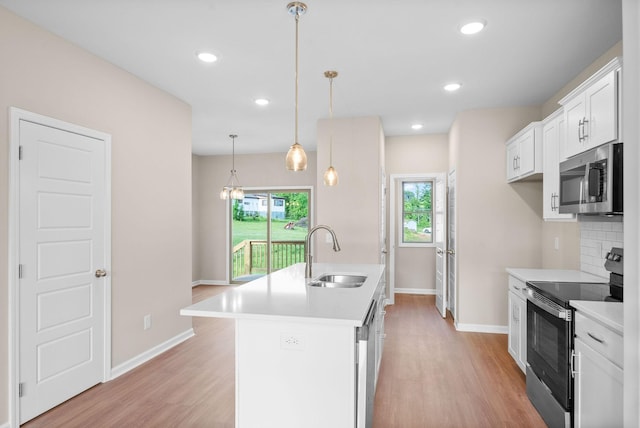 102 Colson Rd, Dover, TN 37058 - kitchen with stainless steel appliances, a sink, baseboards, light wood-type flooring, and recessed lighting