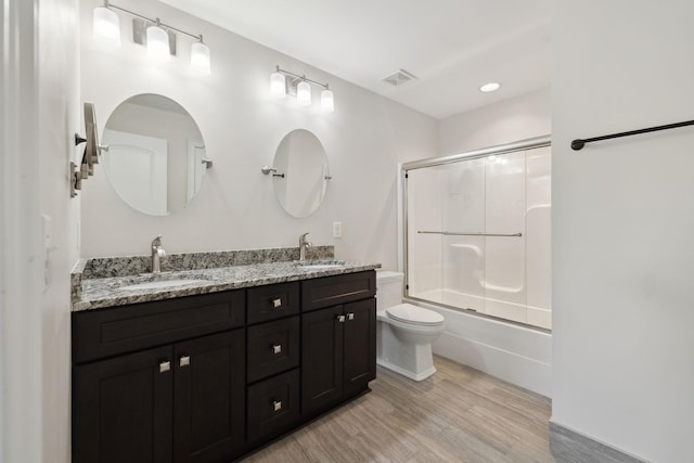 3317 Clovercroft Dr, Murfreesboro, TN 37130 - bathroom featuring toilet, double vanity, wood finished floors, and combined bath / shower with glass door