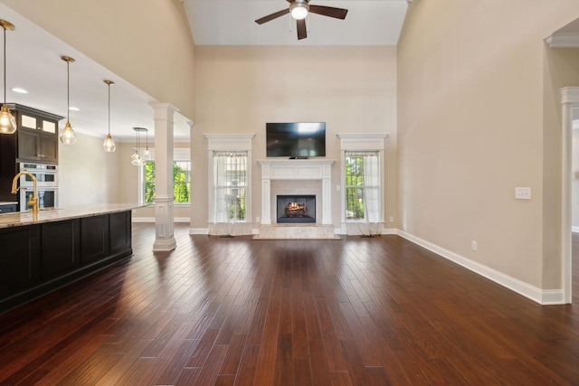 3317 Clovercroft Dr, Murfreesboro, TN 37130 - unfurnished living room featuring a fireplace, a ceiling fan, a towering ceiling, healthy amount of natural light, and baseboards