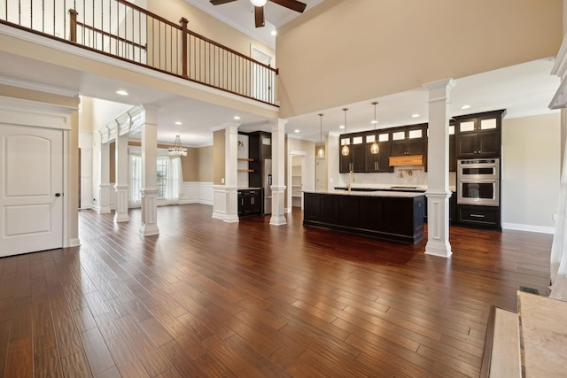 3317 Clovercroft Dr, Murfreesboro, TN 37130 - unfurnished living room featuring ornate columns, crown molding, a ceiling fan, a sink, and dark wood-style flooring