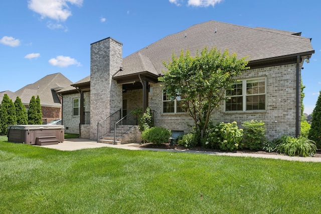 3317 Clovercroft Dr, Murfreesboro, TN 37130 - rear view of property featuring a hot tub, brick siding, a yard, a chimney, and a shingled roof