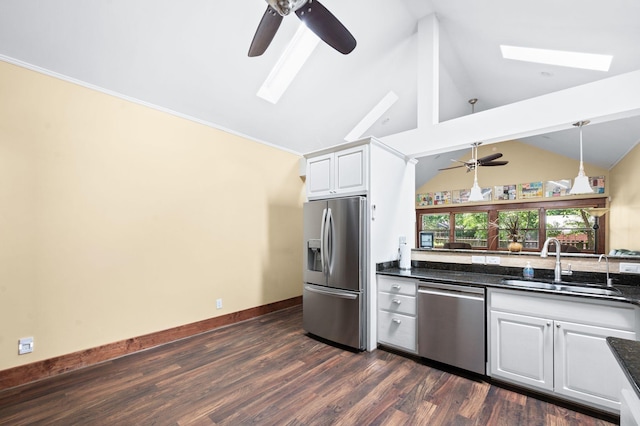 802 N 16th St, Nashville, TN 37206 - kitchen with stainless steel appliances, a ceiling fan, a skylight, a sink, and vaulted ceiling