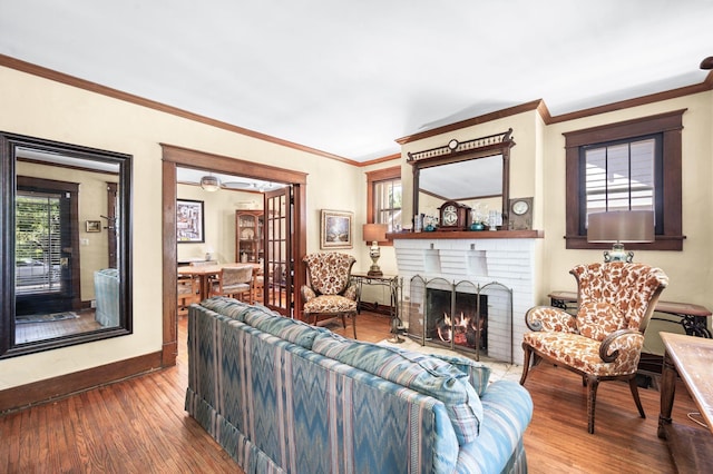 802 N 16th St, Nashville, TN 37206 - living area with wood finished floors, baseboards, crown molding, and a fireplace