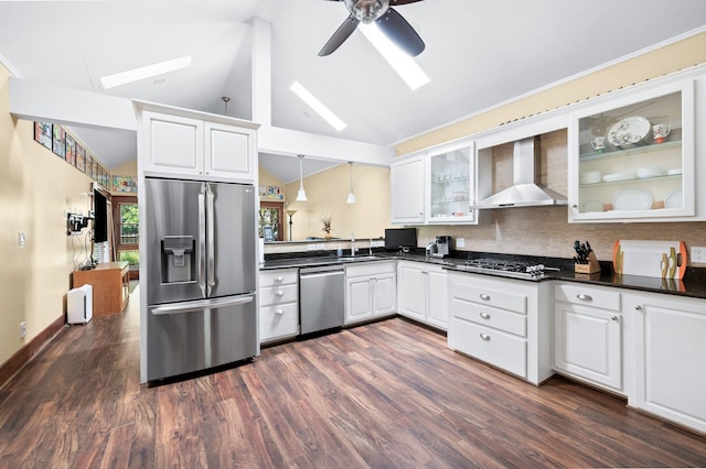 802 N 16th St, Nashville, TN 37206 - kitchen featuring appliances with stainless steel finishes, a skylight, lofted ceiling, wall chimney range hood, and dark countertops