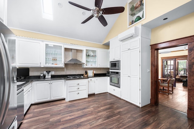 802 N 16th St, Nashville, TN 37206 - kitchen featuring wall chimney exhaust hood, stainless steel appliances, dark countertops, a wall unit AC, and dark wood-style floors
