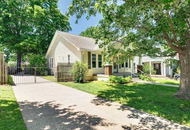 802 N 16th St, Nashville, TN 37206 - view of front of house with a gate, driveway, roof with shingles, and covered porch