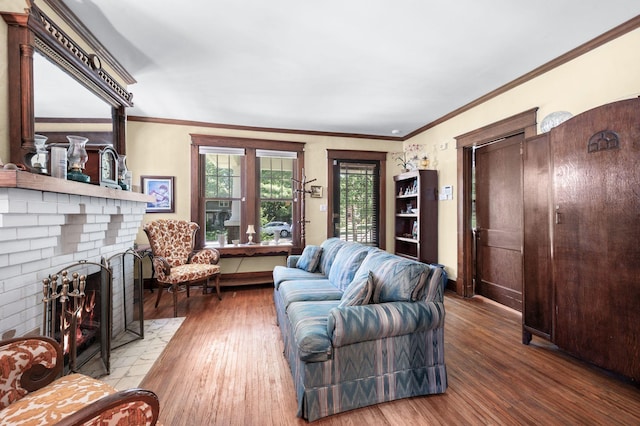 802 N 16th St, Nashville, TN 37206 - living room with wood finished floors, a brick fireplace, baseboards, and crown molding