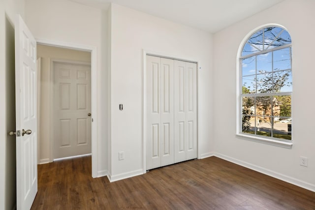 808 Split Oak Ct, Antioch, TN 37013 - unfurnished bedroom with dark wood-style floors, multiple windows, baseboards, and a closet