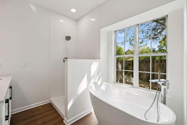 808 Split Oak Ct, Antioch, TN 37013 - bathroom with a freestanding bath, a walk in shower, wood finished floors, and baseboards