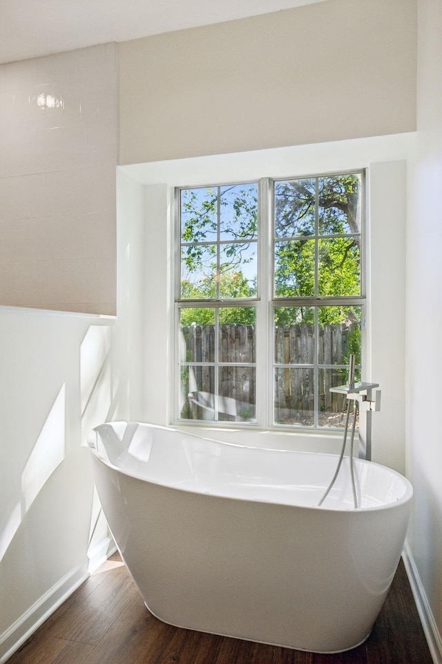 808 Split Oak Ct, Antioch, TN 37013 - bathroom featuring a soaking tub, wood finished floors, and baseboards