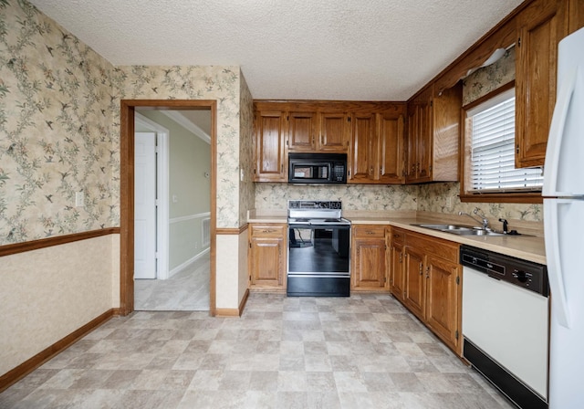 936 E Northfield Blvd, Murfreesboro, TN 37130 - kitchen with black appliances, a sink, light countertops, wallpapered walls, and a textured ceiling