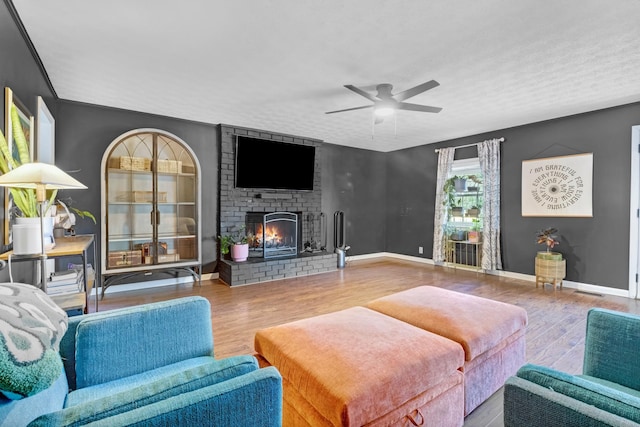 8801 Cedar Grove Rd, Cross Plains, TN 37049 - living area with wood finished floors, a ceiling fan, a fireplace, and baseboards