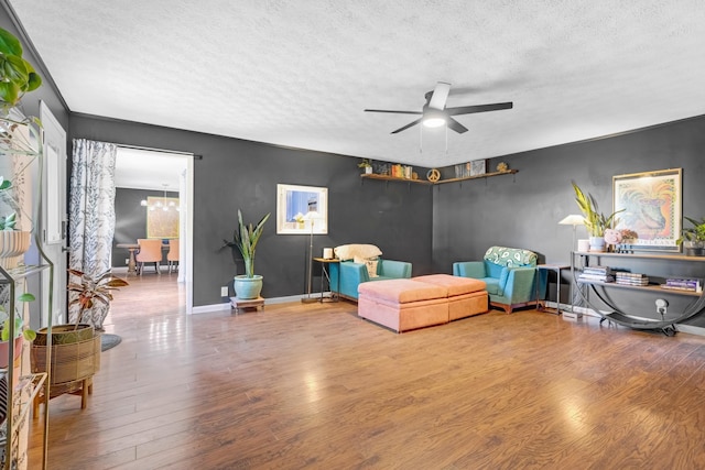 8801 Cedar Grove Rd, Cross Plains, TN 37049 - sitting room with a textured ceiling, wood finished floors, a ceiling fan, a chandelier, and baseboards