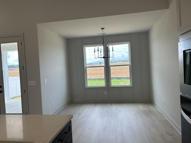 5416 Bridgemore Blvd, Murfreesboro, TN 37129 - unfurnished dining area with light wood finished floors, a chandelier, and baseboards