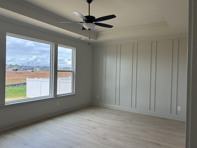 5416 Bridgemore Blvd, Murfreesboro, TN 37129 - spare room featuring a tray ceiling, light wood-type flooring, ceiling fan, crown molding, and a decorative wall
