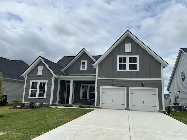 5416 Bridgemore Blvd, Murfreesboro, TN 37129 - view of front facade with board and batten siding, driveway, an attached garage, a front lawn, and central AC
