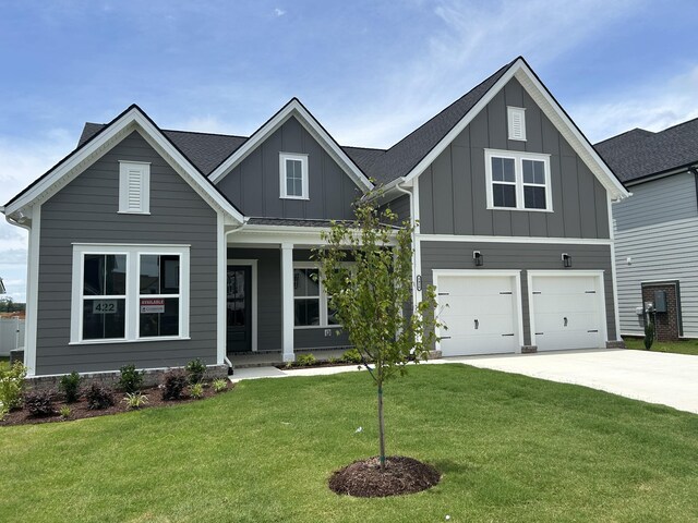 5416 Bridgemore Blvd, Murfreesboro, TN 37129 - view of front of home with board and batten siding, driveway, a porch, an attached garage, and a front yard