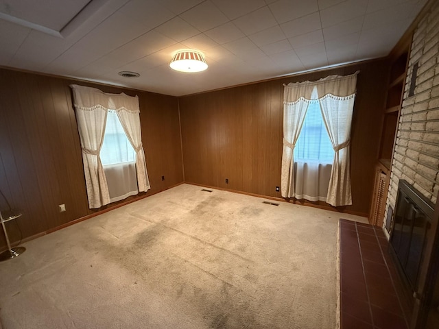 563 Ashe Ave, New Johnsonville, TN 37134 - unfurnished living room with a fireplace, carpet floors, wooden walls, and baseboards