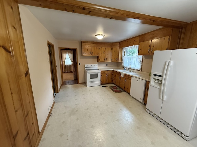 563 Ashe Ave, New Johnsonville, TN 37134 - kitchen featuring white appliances, brown cabinetry, light countertops, light floors, and baseboards