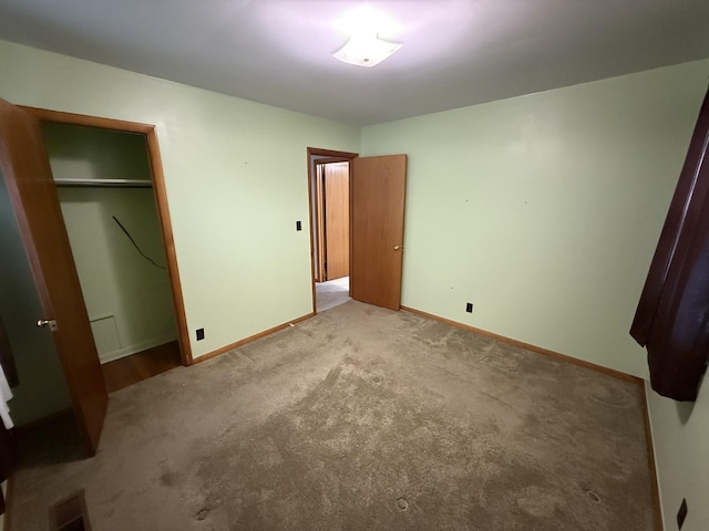 563 Ashe Ave, New Johnsonville, TN 37134 - unfurnished bedroom with baseboards, a closet, and carpet flooring