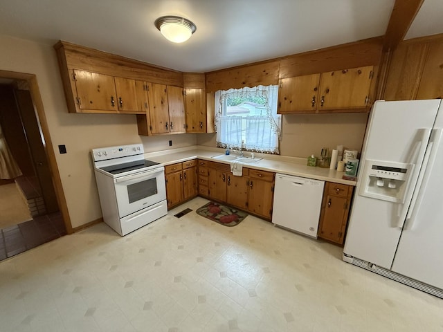 563 Ashe Ave, New Johnsonville, TN 37134 - kitchen featuring white appliances, a sink, and brown cabinets