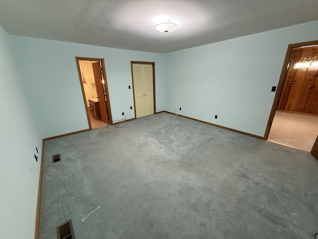 563 Ashe Ave, New Johnsonville, TN 37134 - unfurnished bedroom featuring carpet floors, baseboards, and connected bathroom
