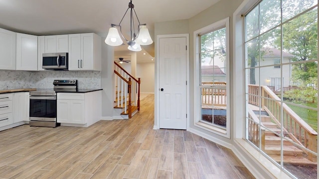 3012 Owendale Dr, Antioch, TN 37013 - kitchen featuring stainless steel appliances, decorative backsplash, a chandelier, and white cabinetry