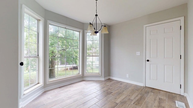 3012 Owendale Dr, Antioch, TN 37013 - unfurnished dining area with baseboards, wood tiled floors, and a chandelier