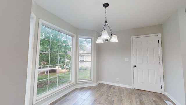 3012 Owendale Dr, Antioch, TN 37013 - unfurnished dining area featuring baseboards, light wood finished floors, and a chandelier