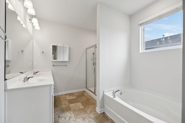 778 Prominence Rd, Columbia, TN 38401 - full bath featuring a bath, double vanity, a shower stall, baseboards, and stone finish floors