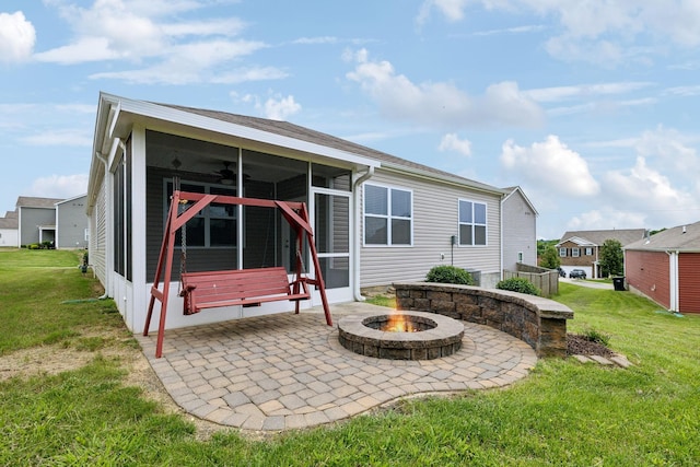 778 Prominence Rd, Columbia, TN 38401 - rear view of property with a sunroom, a patio area, a yard, and an outdoor fire pit
